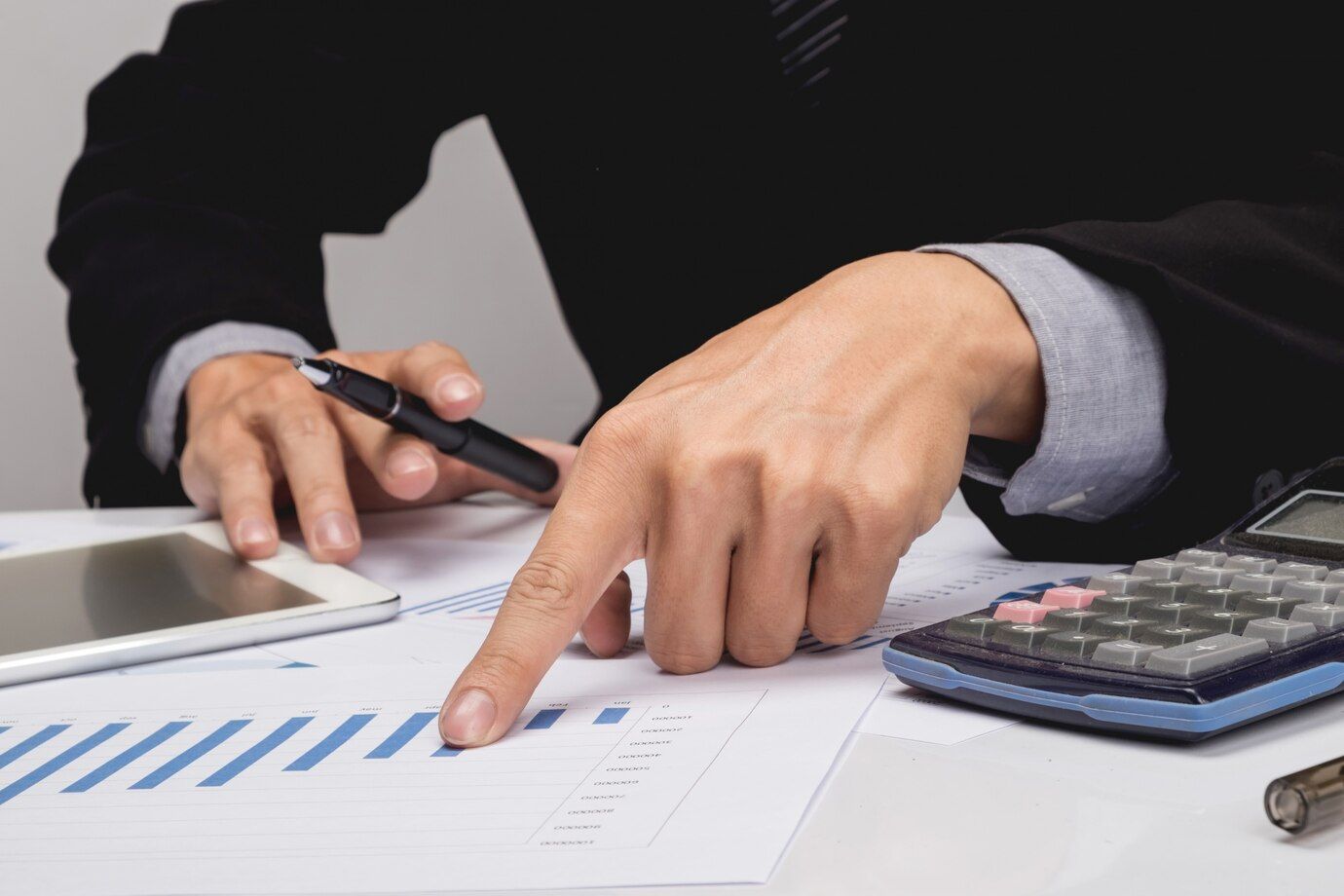 business-people-discussing-financial-charts-closeup-shot-hands-table_1423-167.jpg