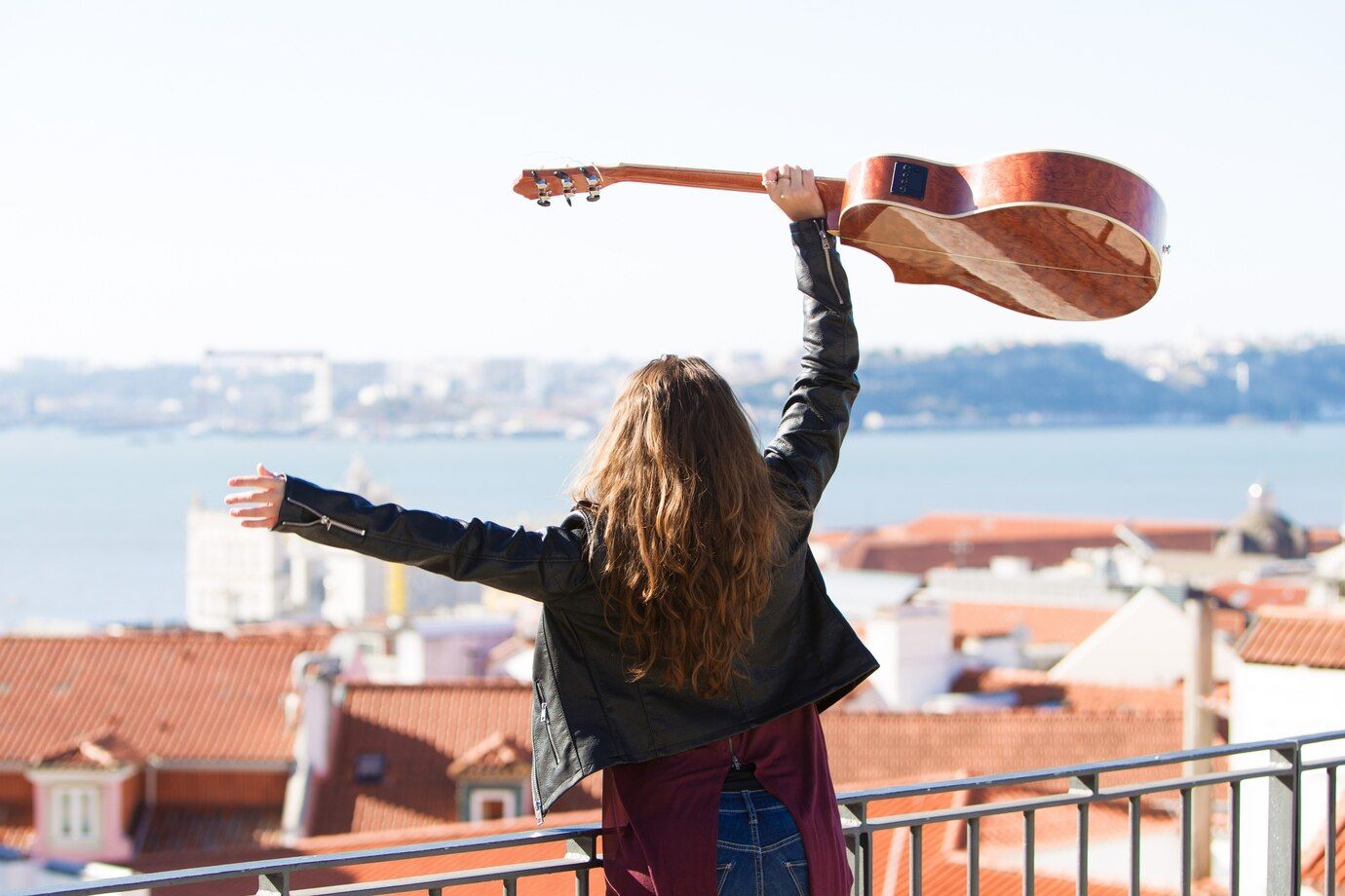 cheerful-girl-holding-guitar-head-rooftop_1262-7169.jpg