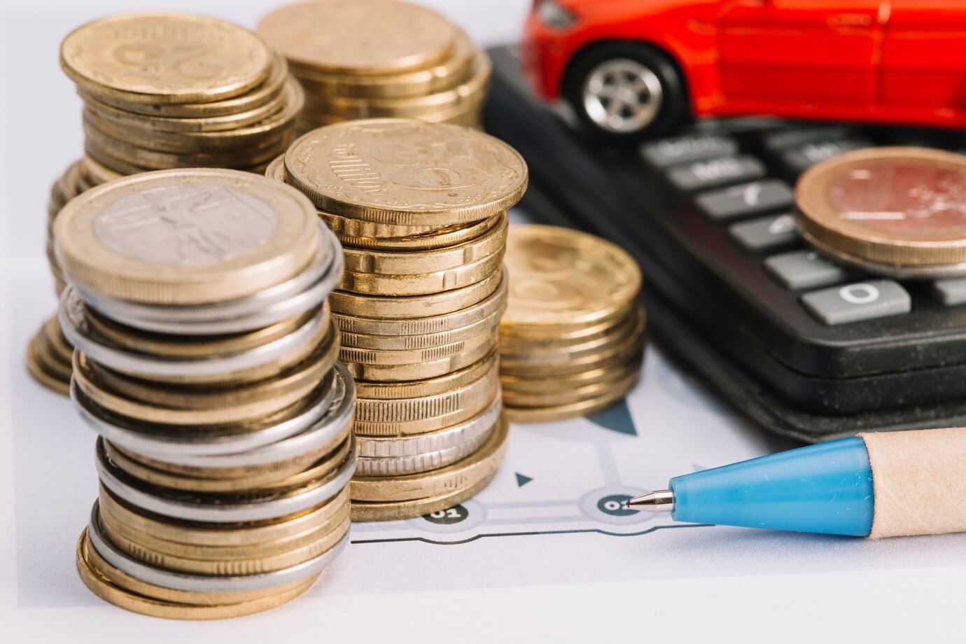 close-up-stacked-coins-pen-calculator_23-2147919136.jpg