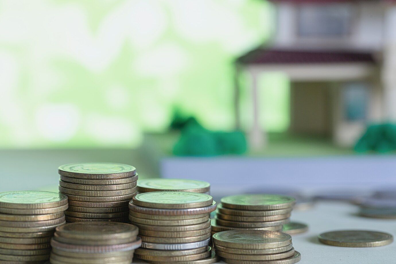 model-house-with-coins-wooden-table_1150-12784.jpg